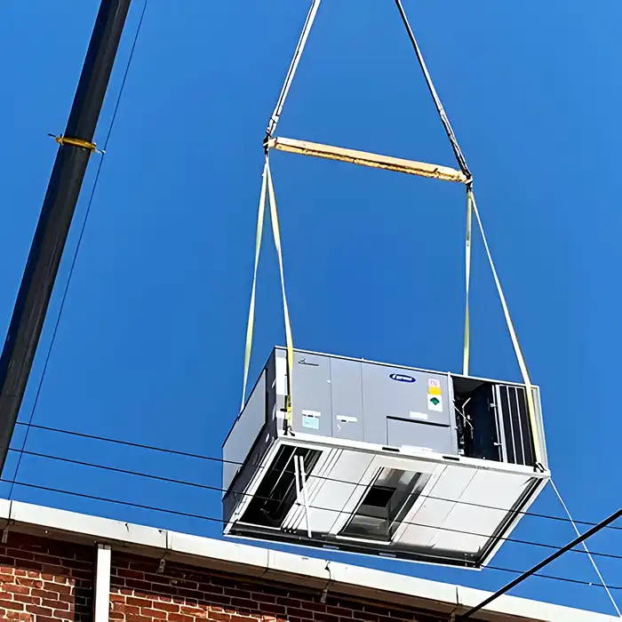 commercial HVAC unit being lifted to rooftop